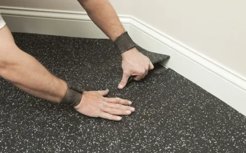 Installing rubber flooring tiles